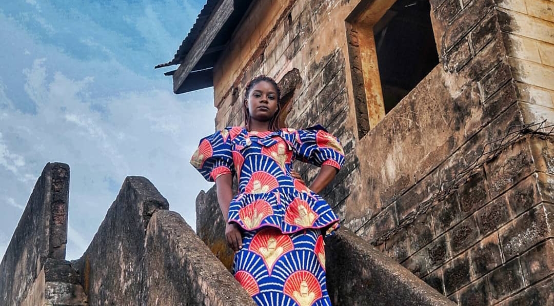 A Ghanaian woman in an African print dress