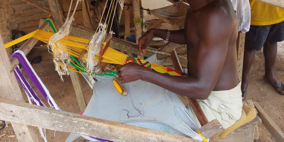 A weaver making kente cloth in Bonwire, Ashanti Region